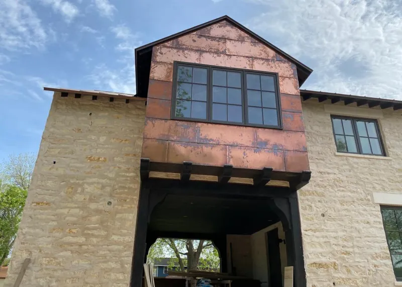 Copper metal panel facade on a stone building for Metal Roof Coating in Huntington Woods