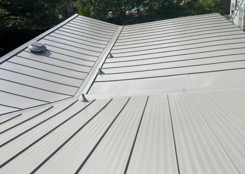 Solar attic fan installed on a metal roof for Roof Ventilation in Huntington Woods